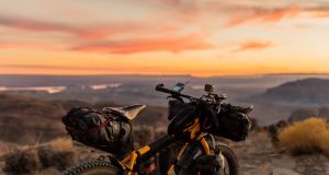Videos! A motorcycle parked on the side of a dirt field