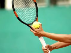 Getting Ready for the New Tennis Season A person holding a racket and a ball
