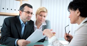 Don’t Fall Prey To Fraud, Recruit Top Lawyers For Cheque Bounce A man and a woman sitting on a paper