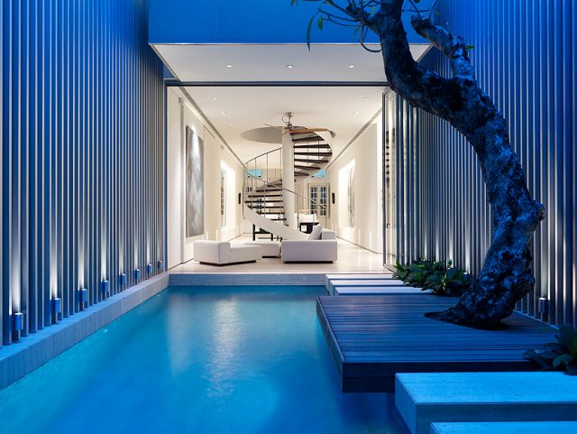 A room with a pool in front of a building