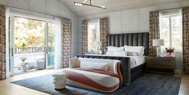 A living room with a bed and a large window