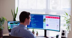 Redesign Your Website for Greater Success with Web Designers A man sitting at a desk in front of a computer screen