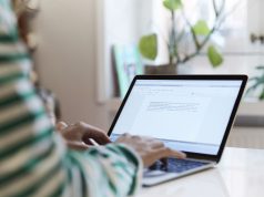 Best Laptop for Writers A person using a laptop computer sitting on top of a table