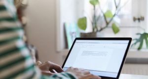 Best Laptop for Writers A person using a laptop computer sitting on top of a table